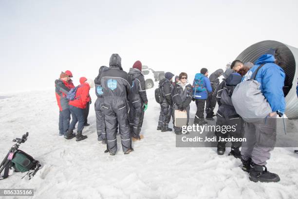 tourists getting ready to enter the ice caves inside the langjokull glacier, iceland - langjokull stock pictures, royalty-free photos & images