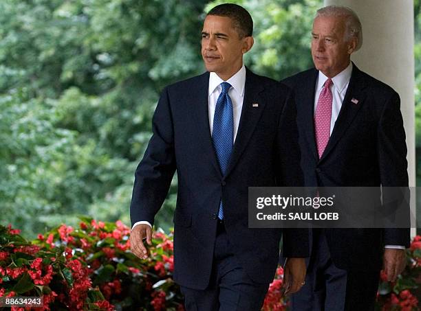 President Barack Obama and US Vice President Joe Biden walk down the West Wing Colonnade prior to Obama signing the Family Smoking Prevention and...