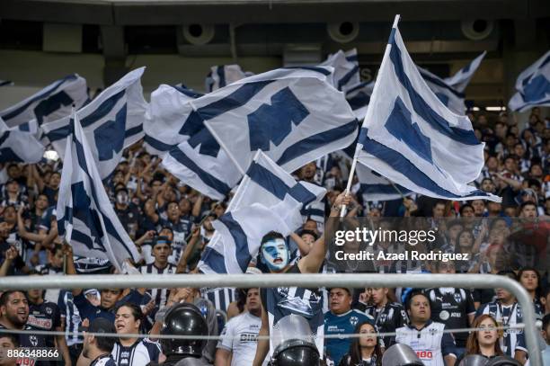 Fans of Monterrey wave flags during the semifinal second leg match between Monterrey and Morelia as part of the Torneo Apertura 2017 Liga MX at BBVA...