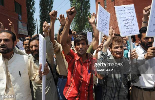 Kashmiri teachers shout slogans during a protest march over the alleged rape and murder of two Muslim women, in Srinagar on June 23, 2009. Residents...
