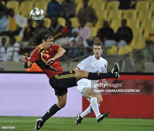 Spain's defender Carles Puyol shoots past New Zealand Aaron Scott during theFIFA Confederations Cup football match New Zealand vs Spain on June 14,...