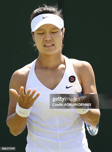 China's Na Li looks at her hands after a fall during play against Kazhakstan's Galina Voskoboeva during their first round match of the 2009 Wimbledon...