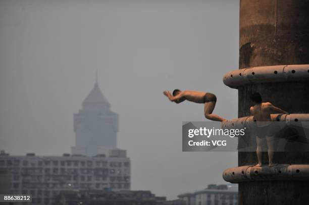 Boy jumps into the Hanjiang River to cool down on June 22, 2009 in Wuhan of Hubei Province, China. Wuhan is known as one of the "Three Furnaces" for...