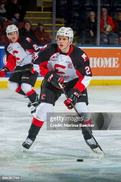 Dennis Cholowski of the Prince George Cougars skates with the puck against the Kelowna Rockets at Prospera Place on November 29, 2017 in Kelowna,...