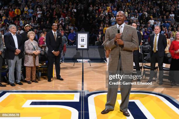 Alex English speaks to the crowd as the Denver Nuggets retire Fat Levers jersey to the Pepsi Center rafters at a halftime ceremony during the game...