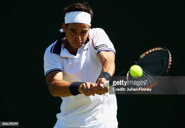Frederico Gil of Portugal plays a backhand during the men's singles first round match against Paul-Henri Mathieu of France on Day Two of the...