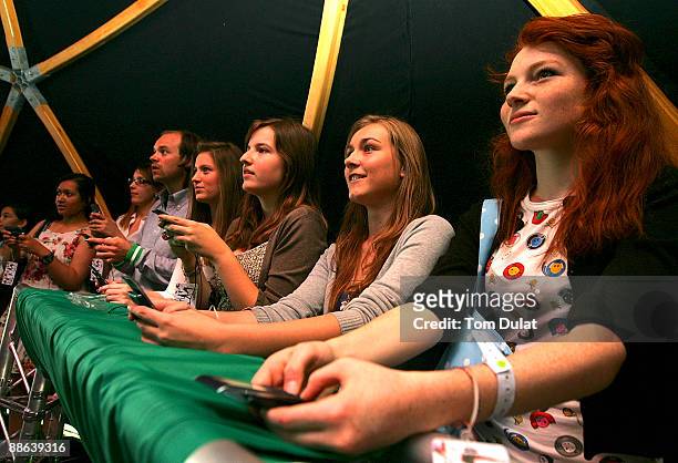 Group of fans are challenged by World No 7 Vera Zvonareva in an interactive mobile tennis game on a giant plasma screen during the WTA live digital...