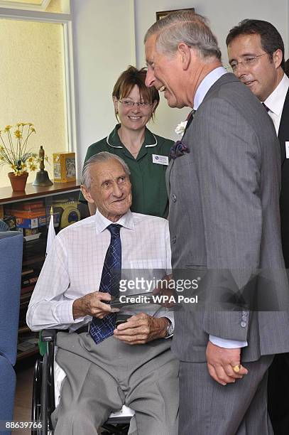 Prince Charles, Prince of Wales and nurse Annette Morgan chat with Alfred 'Harry' Moor who served in the Royal Horse Guards and was at Prince...