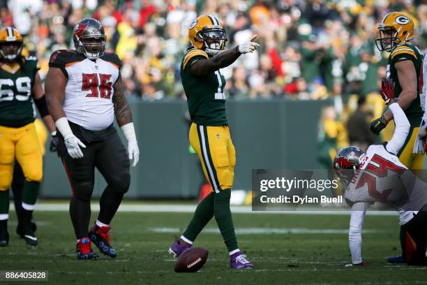 Davante Adams of the Green Bay Packers reacts after making a catch in the first quarter against the Tampa Bay Buccaneers at Lambeau Field on December...