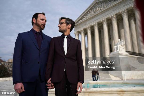 Charlie Craig and Dave Mullins , the gay couple who were denied having their wedding cake baked by cake artist Jack Phillips, look at each other...