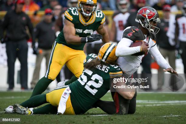 Clay Matthews of the Green Bay Packers tackles Jameis Winston of the Tampa Bay Buccaneers in the second quarter at Lambeau Field on December 3, 2017...