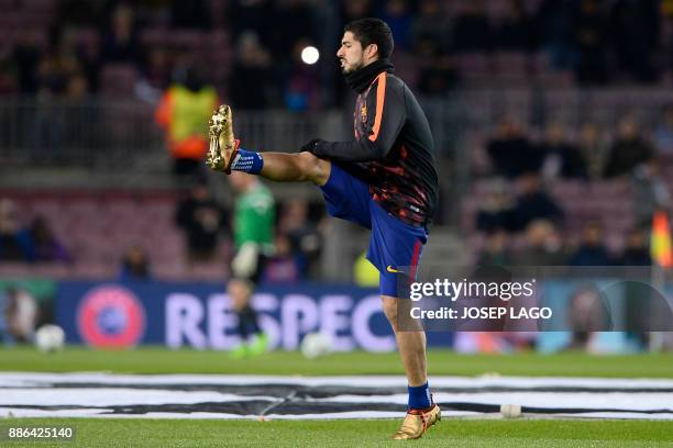 Barcelona's Uruguayan forward Luis Suarez warms up ahead of the UEFA Champions League football match FC Barcelona vs Sporting CP at the Camp Nou...
