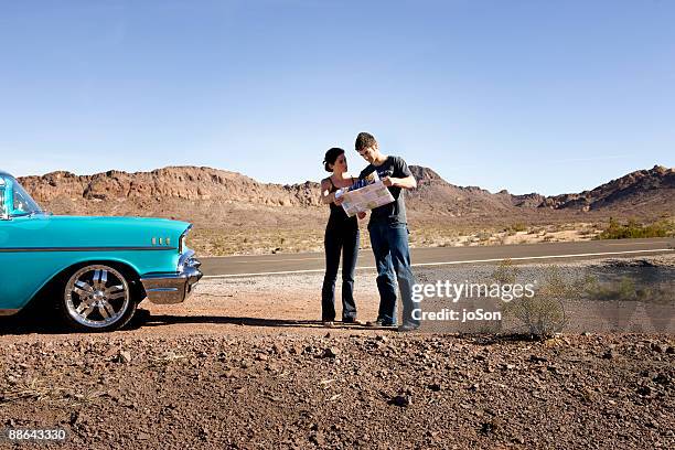 couple looking at map - las vegas map stock pictures, royalty-free photos & images