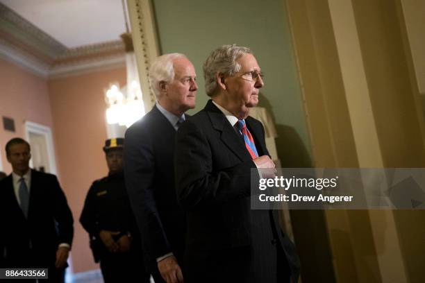 Sen. John Cornyn and Senate Majority Leader Mitch McConnell leave a meeting with Senate Republicans on Capitol Hill, December 5, 2017 in Washington,...