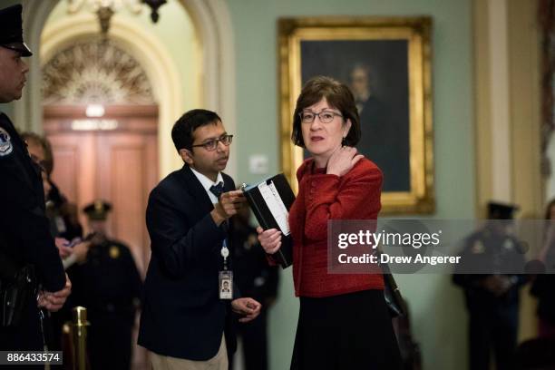 Sen. Susan Collins talks to a reporter as she leaves a meeting with Senate Republicans on Capitol Hill, December 5, 2017 in Washington, DC. After the...