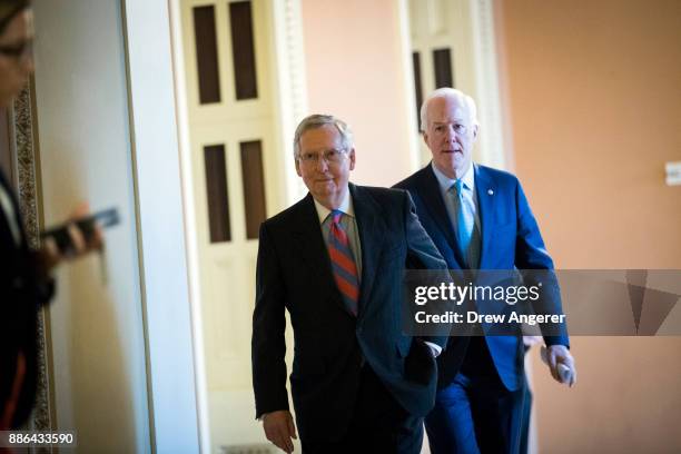 Senate Majority Leader Mitch McConnell and Sen. John Cornyn leave a meeting with Senate Republicans on Capitol Hill, December 5, 2017 in Washington,...