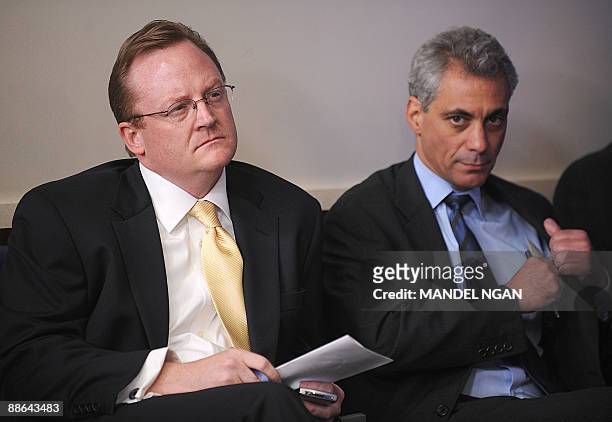 White House Chief of Staff Rahm Emanuel and Press Secretary Robert Gibbs listen as US President Barack Obama speaks during a press conference June...