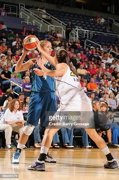 Christi Thomas of the Minnesota Lynx moves the ball against Brooke Smith of the Phoenix Mercury during the WNBA game on June 17, 2009 at US Airways...