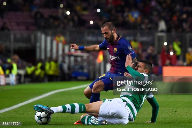 Barcelona's Spanish midfielder Aleix Vidal challenges Sporting's Argentinian forward Rodrigo Battaglia during the UEFA Champions League football...