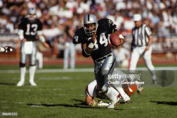Running back Bo Jackson of Los Angeles Raiders breaks free on the open field against the Cincinnati Bengals defense during the 1990 AFC Divisional...