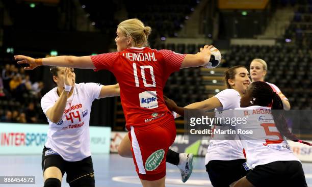 Kathrine Heindahl of Denmark challenges Manel Kouki of Tunisia during the IHF Women's Handball World Championship group C match between Denmark and...