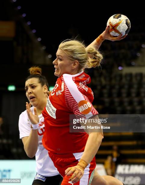 Kathrine Heindahl of Denmark challenges Manel Kouki of Tunisia during the IHF Women's Handball World Championship group C match between Denmark and...