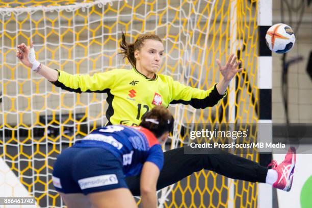 Nora Mork of Norway and Weronika Gawlik of Poland in action during IHF Women's Handball World Championship match between Norway and Poland on...