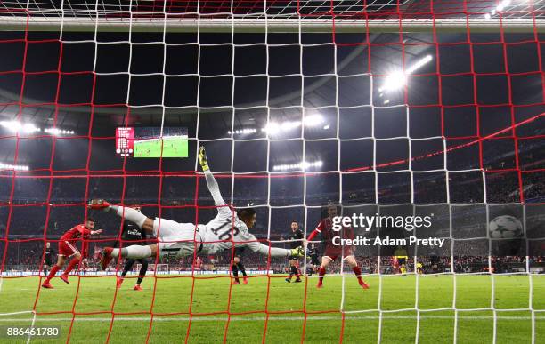 Corentin Tolisso of Bayern Muenchen scores his sides second goal past Alphonse Areola of PSG during the UEFA Champions League group B match between...