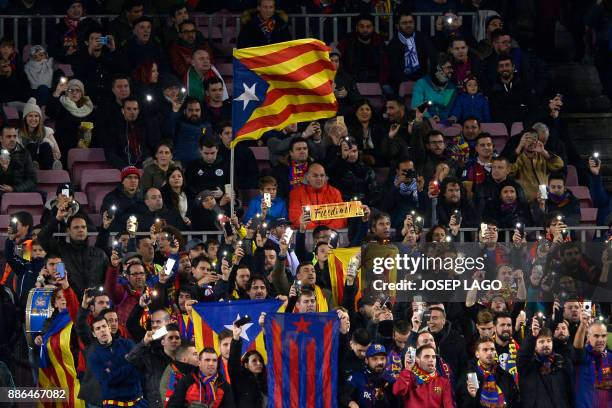 Barcelona supporters wave pro-independence Catalan Estelada flags and turn on their mobile phone flashlights as a sign of protest calling for the...