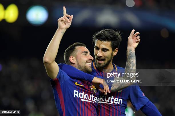 Barcelona's Spanish forward Paco Alcacer celebrates with Barcelona's Portuguese midfielder Andre Gomes after scoring a goal during the UEFA Champions...