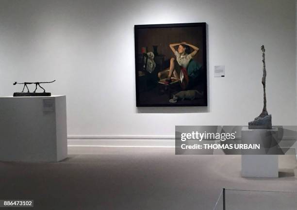 The 1938 painting entitled "Therese Dreaming" by French-Polish artist known as Balthus, born Balthasar Klossowski de Rola, is seen near his other...