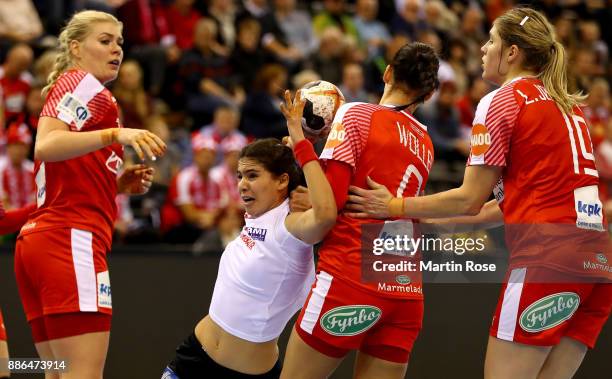 Kathrine Heindahl and Fie Woller of Denmark challenge Rakia Rezgui of Tunisia during the IHF Women's Handball World Championship group C match...