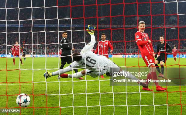 Corentin Tolisso of Bayern Muenchen scores his sides third goal past Alphonse Areola of PSG during the UEFA Champions League group B match between...