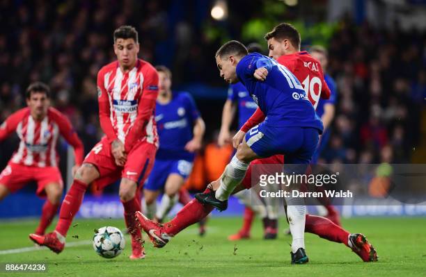 Eden Hazard of Chelsea shoots and his shot is deflected in by Stefan Savic of Atletico Madrid for Chelsea first goal during the UEFA Champions League...