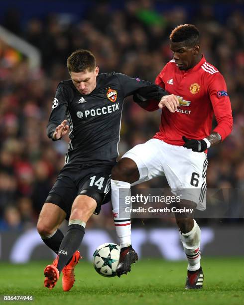 Kirill Nababkin of CSKA Moscow is challenged by Paul Pogba of Manchester United during the UEFA Champions League group A match between Manchester...