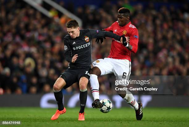 Kirill Nababkin of CSKA Moscow is challenged by Paul Pogba of Manchester United during the UEFA Champions League group A match between Manchester...