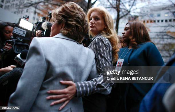 Summer Zervos a former contestant on The Apprentice" looks at the camera as she embraces lawyer Gloria Allred after they leave the New York County...