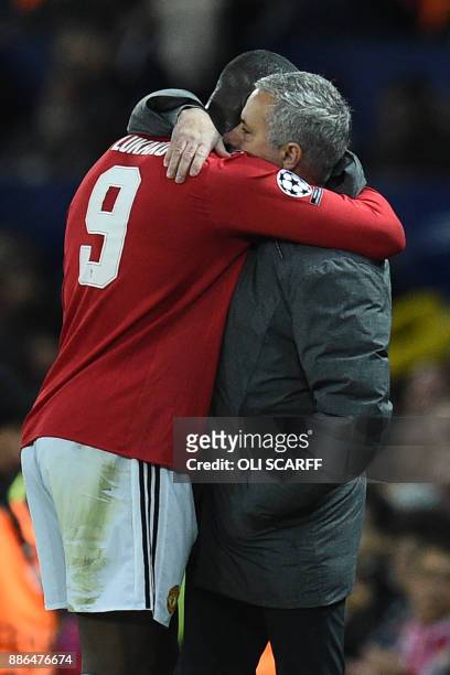Manchester United's Portuguese manager Jose Mourinho embraces Manchester United's Belgian striker Romelu Lukaku as he is substituted during the UEFA...