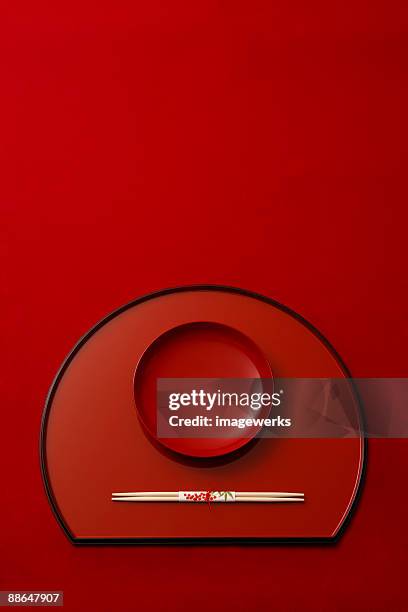 japanese lacquer ware against red background, close-up - lackiert stock-fotos und bilder