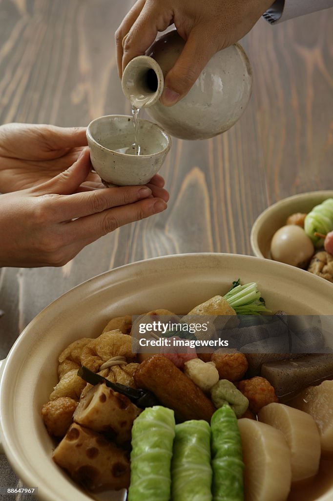 Man pouring sake into sake cup