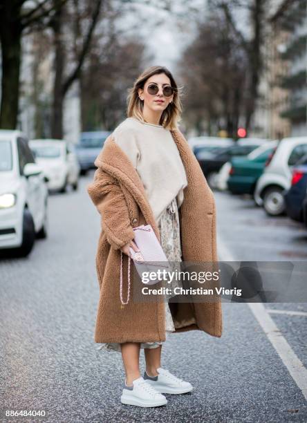 Aylin Koenig wearing a beige Max Mara coat, white sneakers Alexander McQueen, By Malene Birger knit, Zimermann dress, pink Chanel bag, Ray Ban...