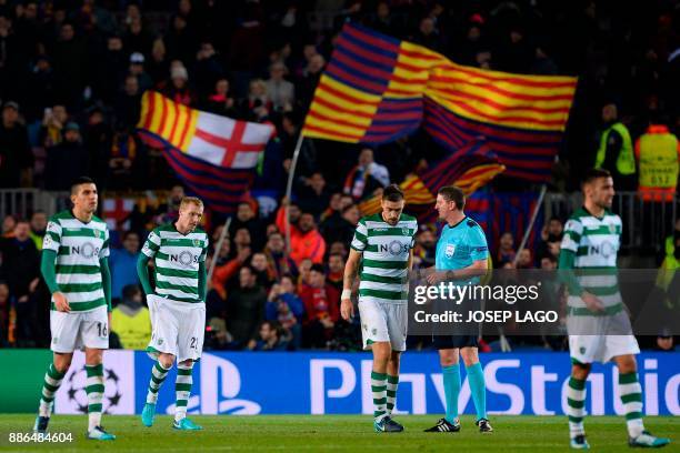 Sporting's players react at the end of the UEFA Champions League football match FC Barcelona vs Sporting CP at the Camp Nou stadium in Barcelona on...