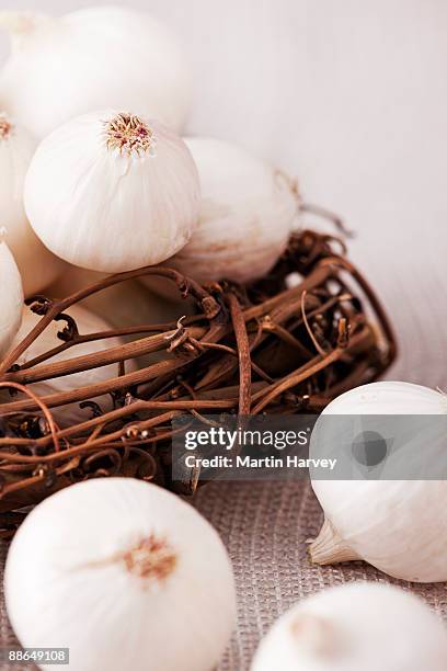 small white pearl onions in woven basket. - african woven baskets stock pictures, royalty-free photos & images