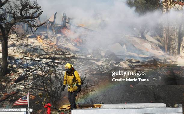 Firefighter works while battling flames from the Thomas Fire in a residential neighborhood on December 5, 2017 in Ventura, California. Around 45,000...