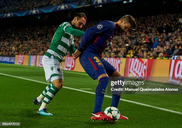 Gerard Pique of FC Barcelona is challenged by Bruno Cesar of Sporting CP during the UEFA Champions League group D match between FC Barcelona and...