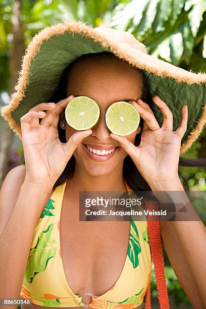 woman covering eyes with limes - the cayes stock pictures, royalty-free photos & images