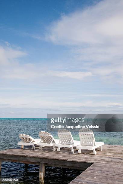 lounge chairs on pier - the cayes stock pictures, royalty-free photos & images