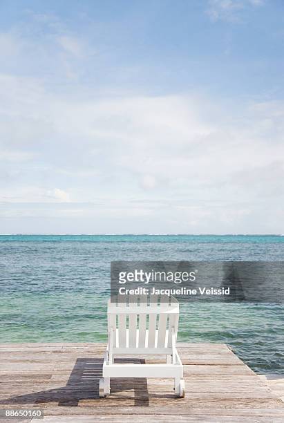 lounge chair on pier - the cayes stock pictures, royalty-free photos & images