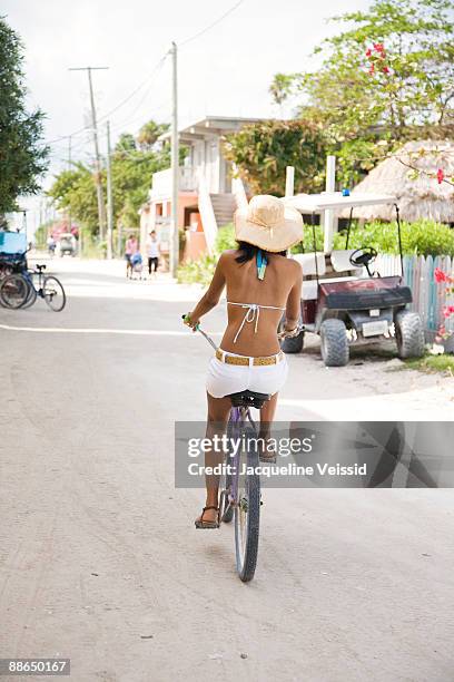 woman riding bicycle - the cayes stock pictures, royalty-free photos & images