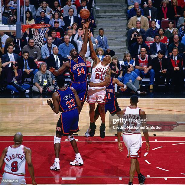 Anthony Mason of the New York Knicks and Dennis Rodman of the Chicago Bulls battle for a rebound in Game Five of the Eastern Conference Semifinals...